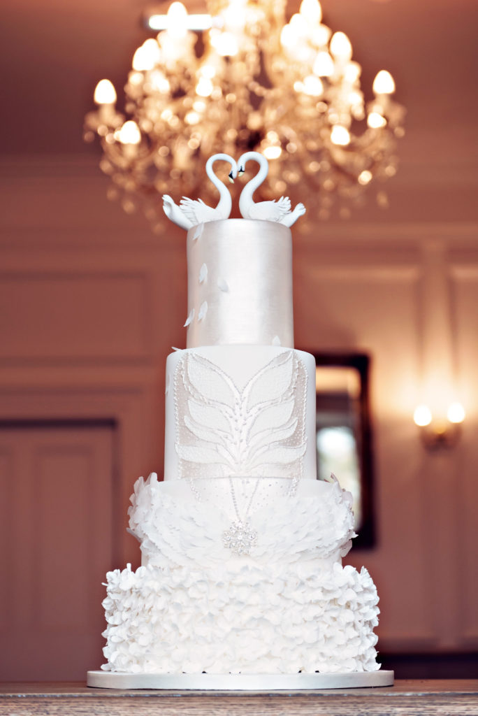 Photograph showing an elegant wedding cake inspired by Swan Lake the ballet