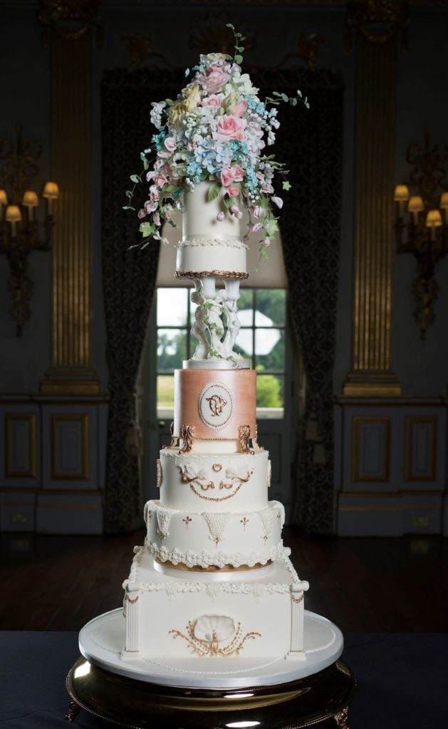 Photograph showing an elegant bespoke wedding cake in The Stucco Ballroom in Knowsley Hall