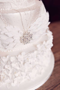Luxury wedding cake with sugar flowers and sugar feather headdress