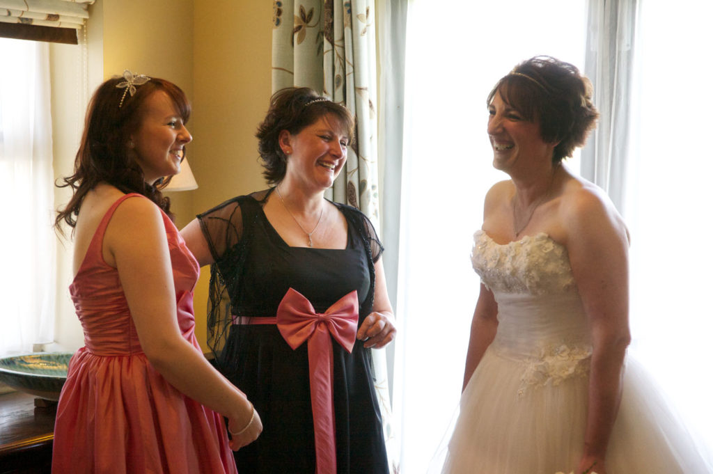 Bride-and-Bridesmaids-laughing-The-Cake-Pavilion.