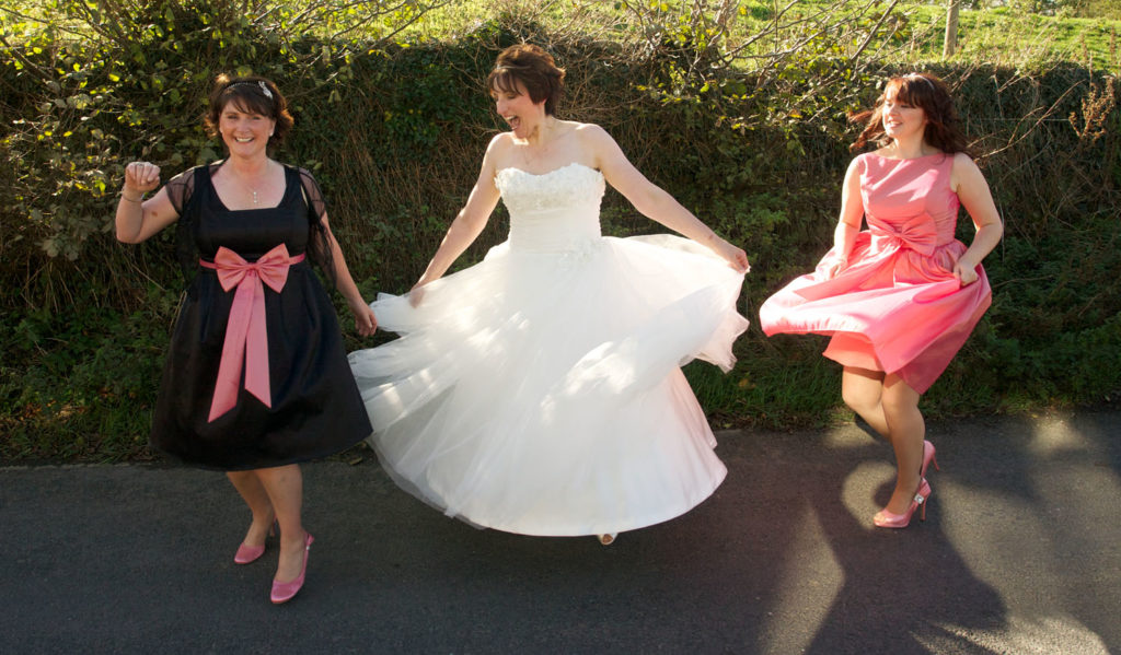 Bride and bridesmaids twirling