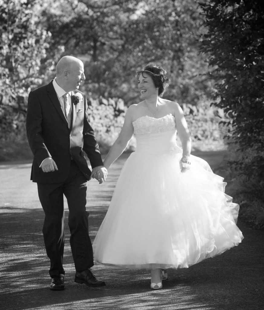 Bride and groom walking outside