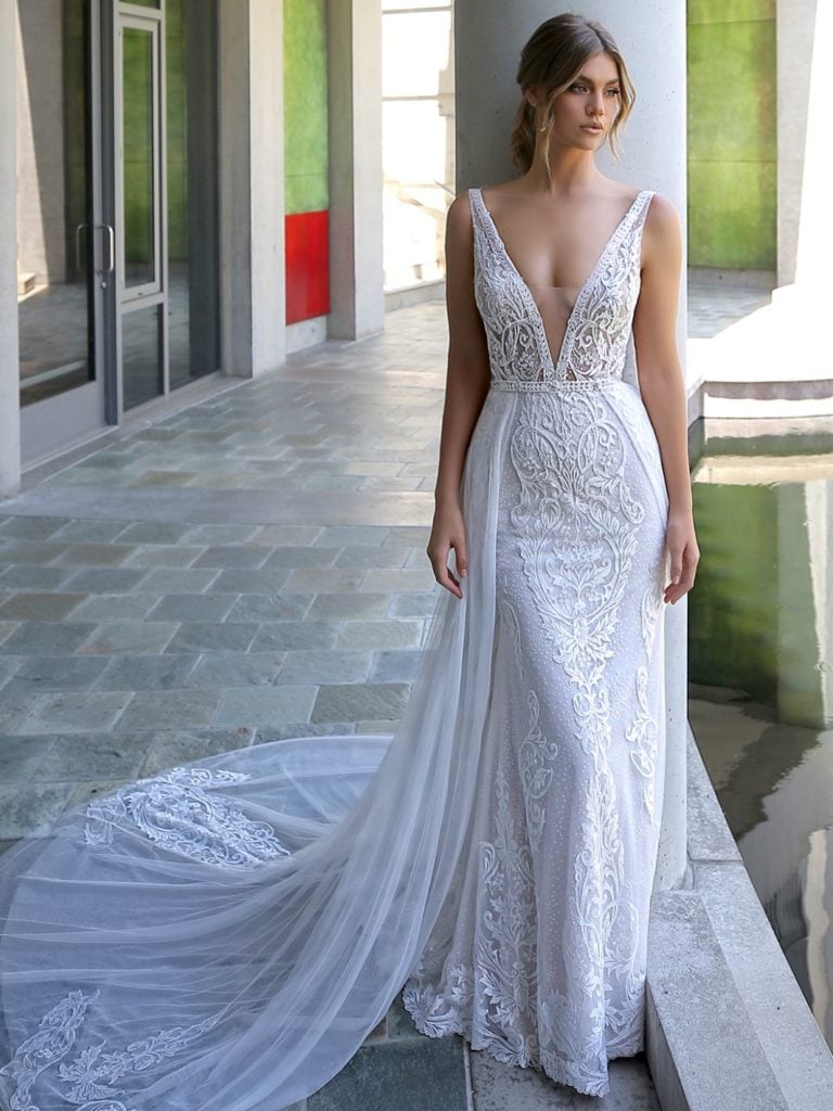 Bride in lace wedding dress with deep plunge neck line