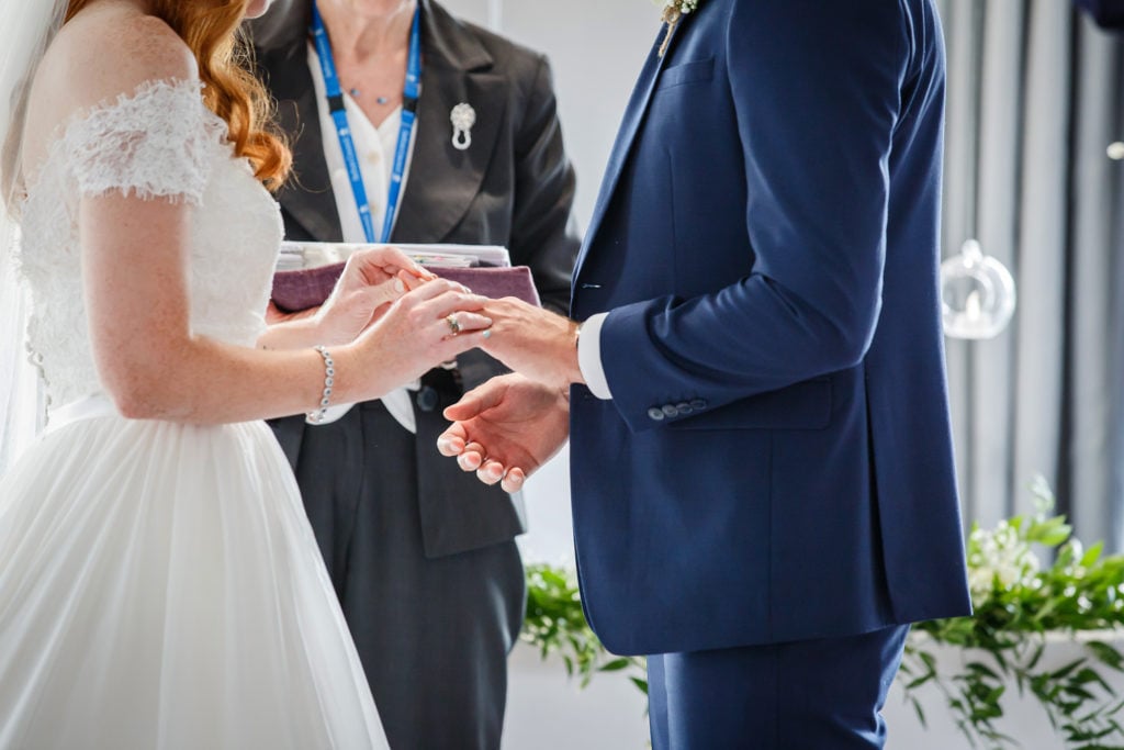 Bride and groom exchanging rings