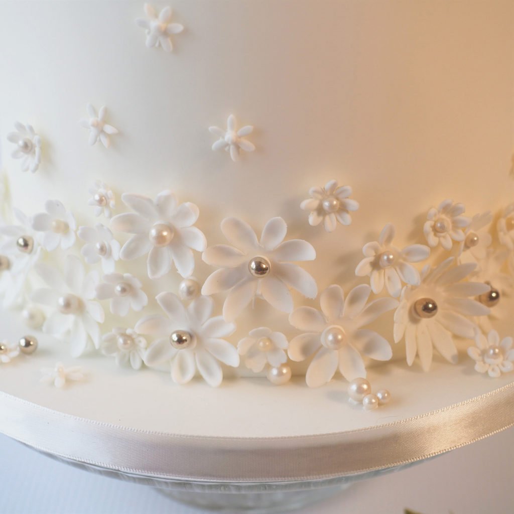 Contemporary white sugar flowers on wedding cake