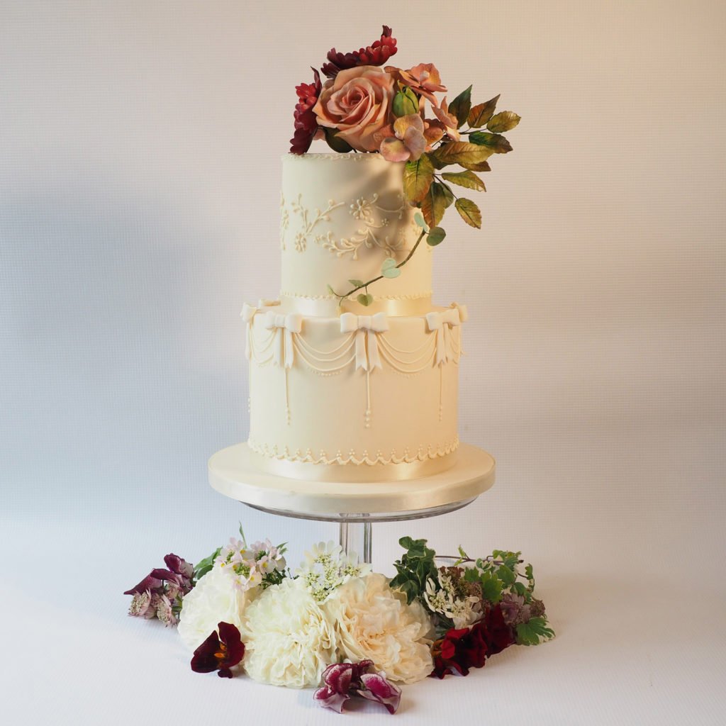 Two tier ivory wedding cake with sugar flowers