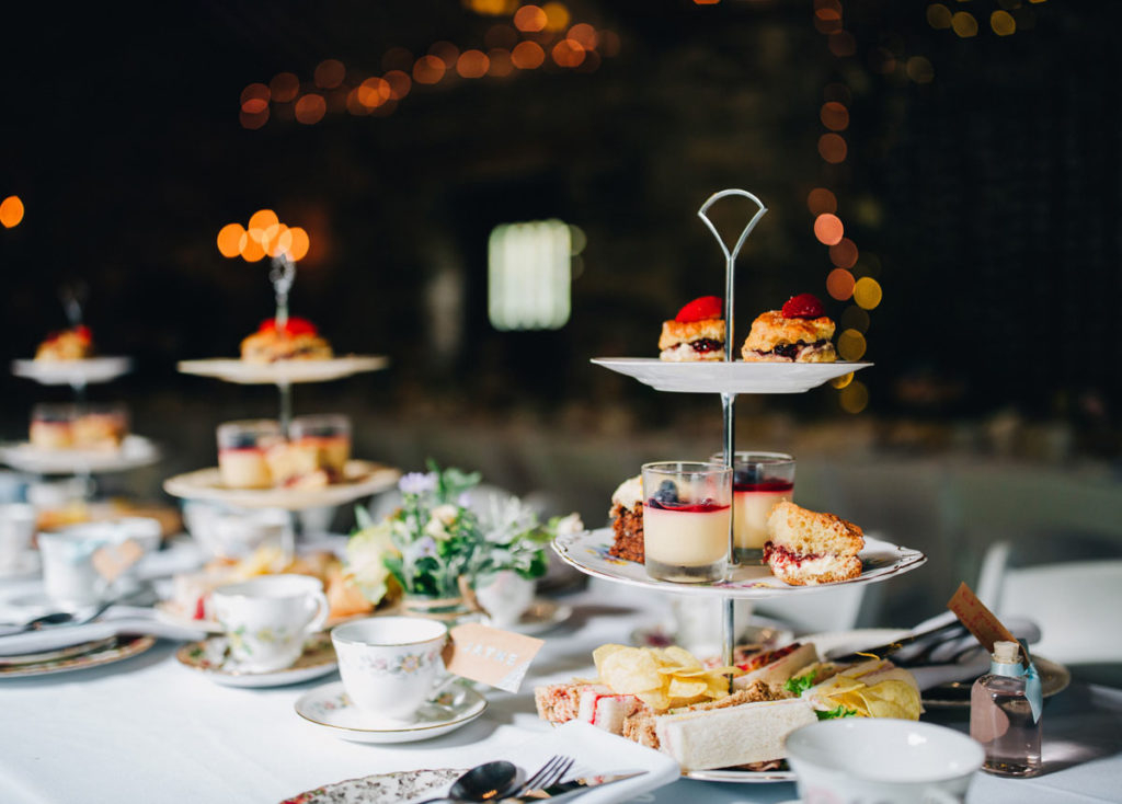 Afternoon tea with wedding favours of homemade candle vintage teacups