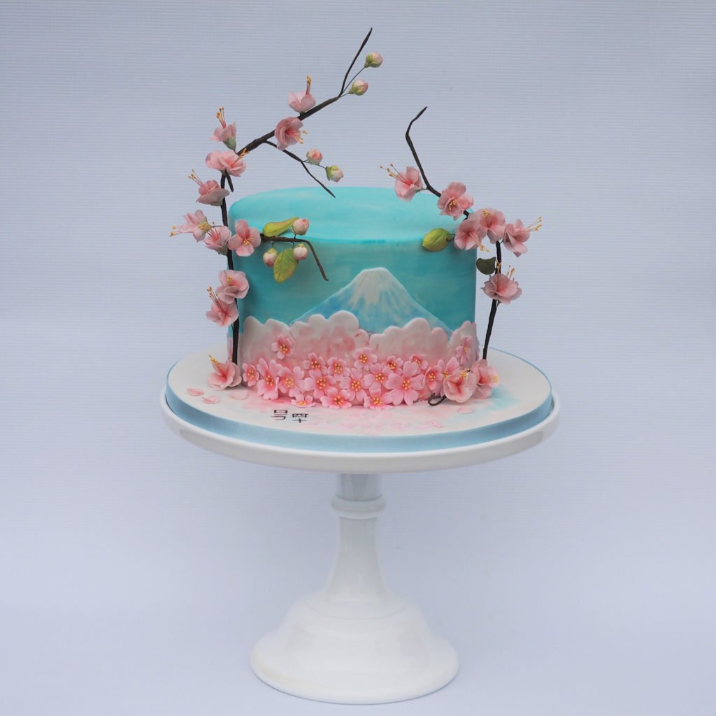 Japanese inspired cake with handpainted Mount Fugi nad sugar cherry blossom branches