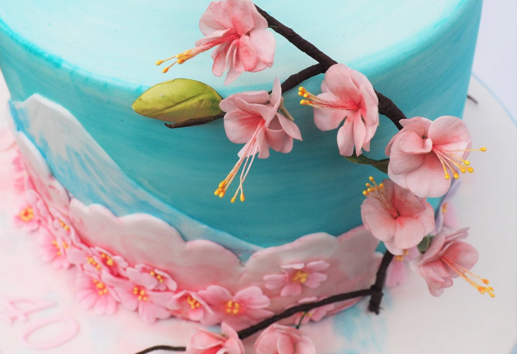 Sugar cherry blossom on a handpainted cake